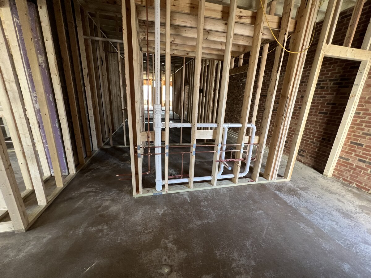 Commercial rough-in plumbing with PVC drain and PEX supply lines